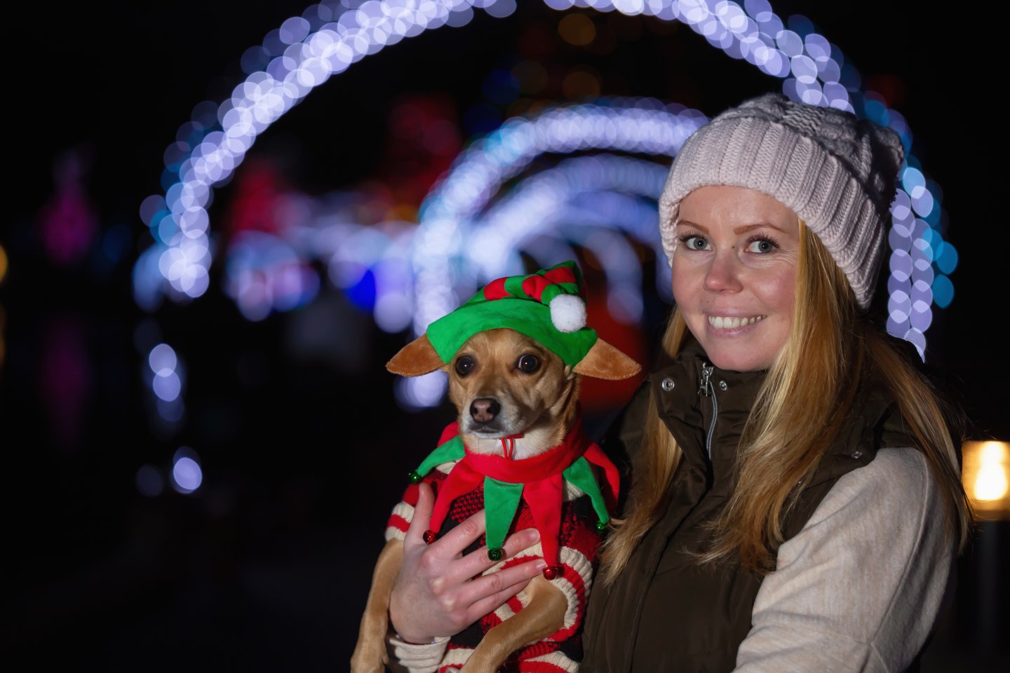 woman and dog in front of lights