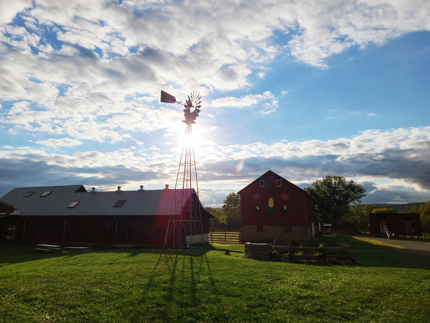 Temple Hall Farm with sun and clouds