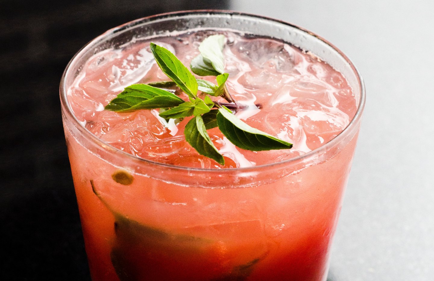 pink cocktail with mint leaves on top