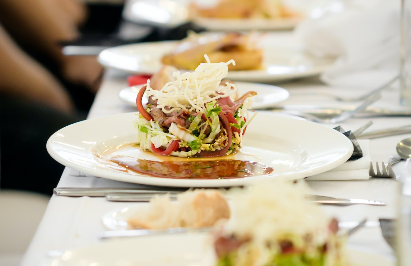 entree on table with white plate and silverware set