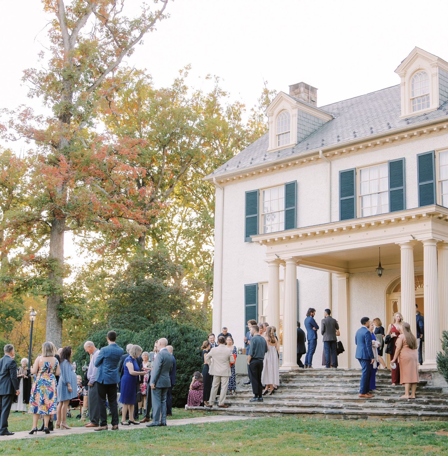 Cocktail hour in front of Rust Manor House. Wedding guests drinking cocktails.