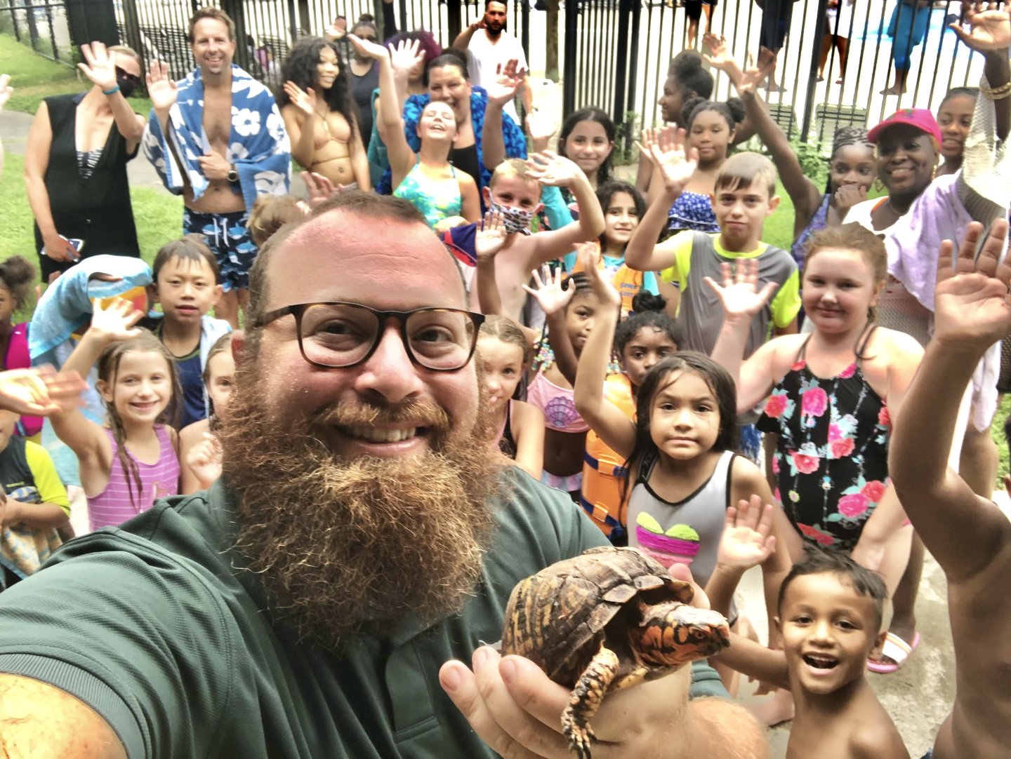 NOVA Parks Roving Naturalist holding a turtle with kids in background