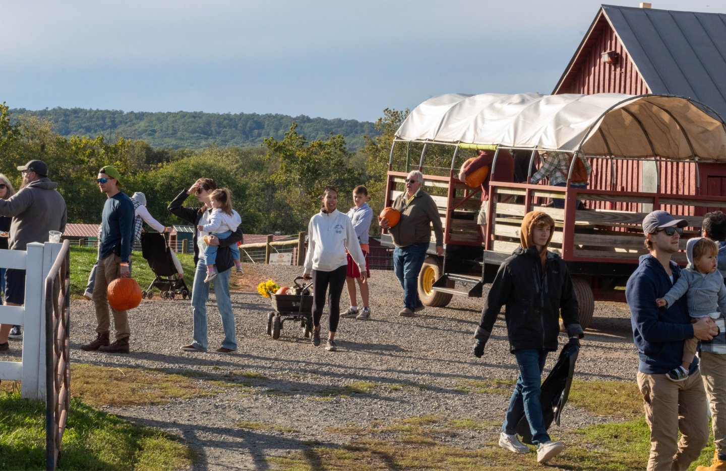 People exiting wagon ride with pumpkins and sunflowers at Temple Hall Farm's Pumpkin Patch
