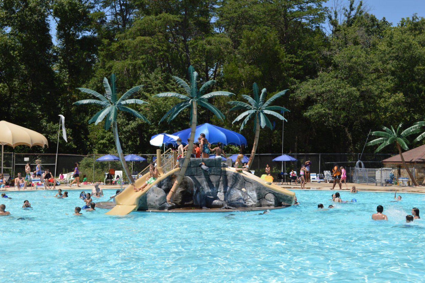 Atlantis Waterpark two slides in the middle of the pool people playing in the pool