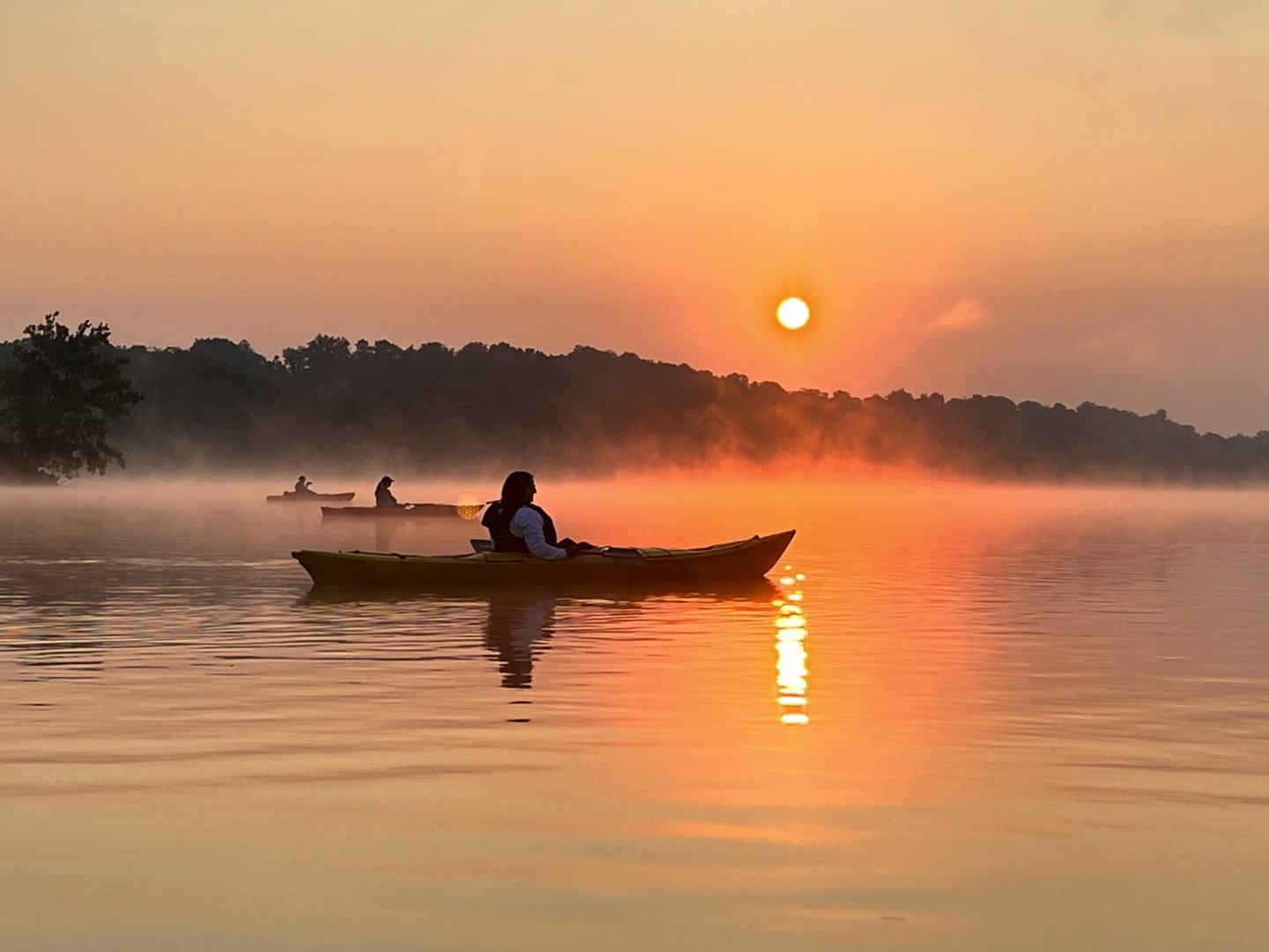 a kayak on the water during sunrise