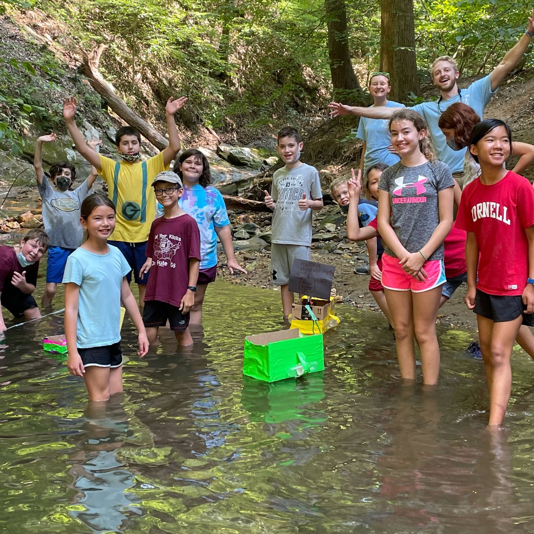 A group of Camp Overlook campers and counselor exploring a stream