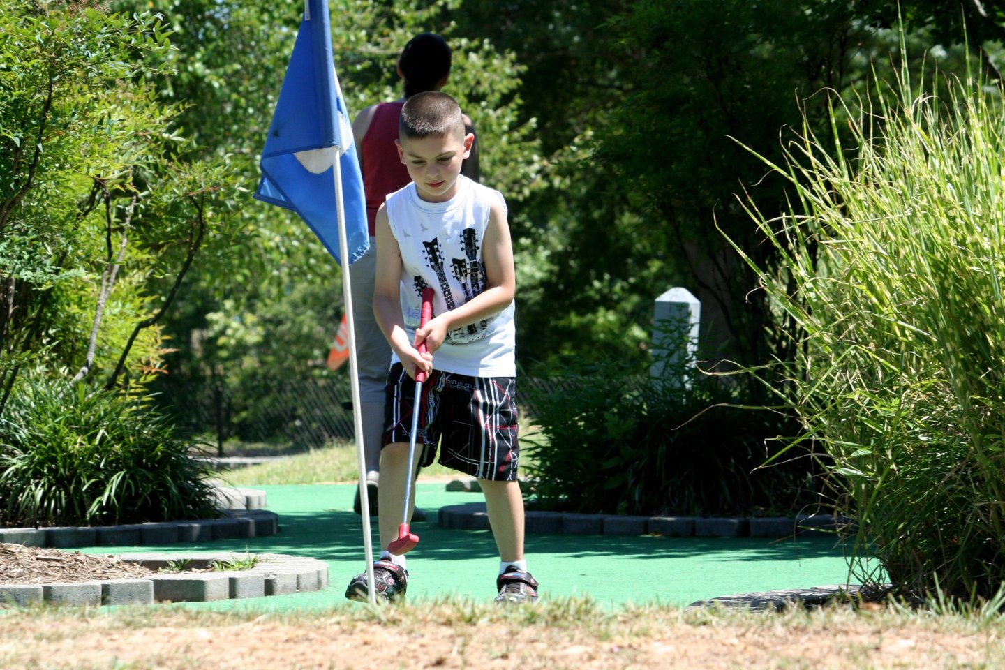 Boy playing mini golf at Cameron Run Regional Park