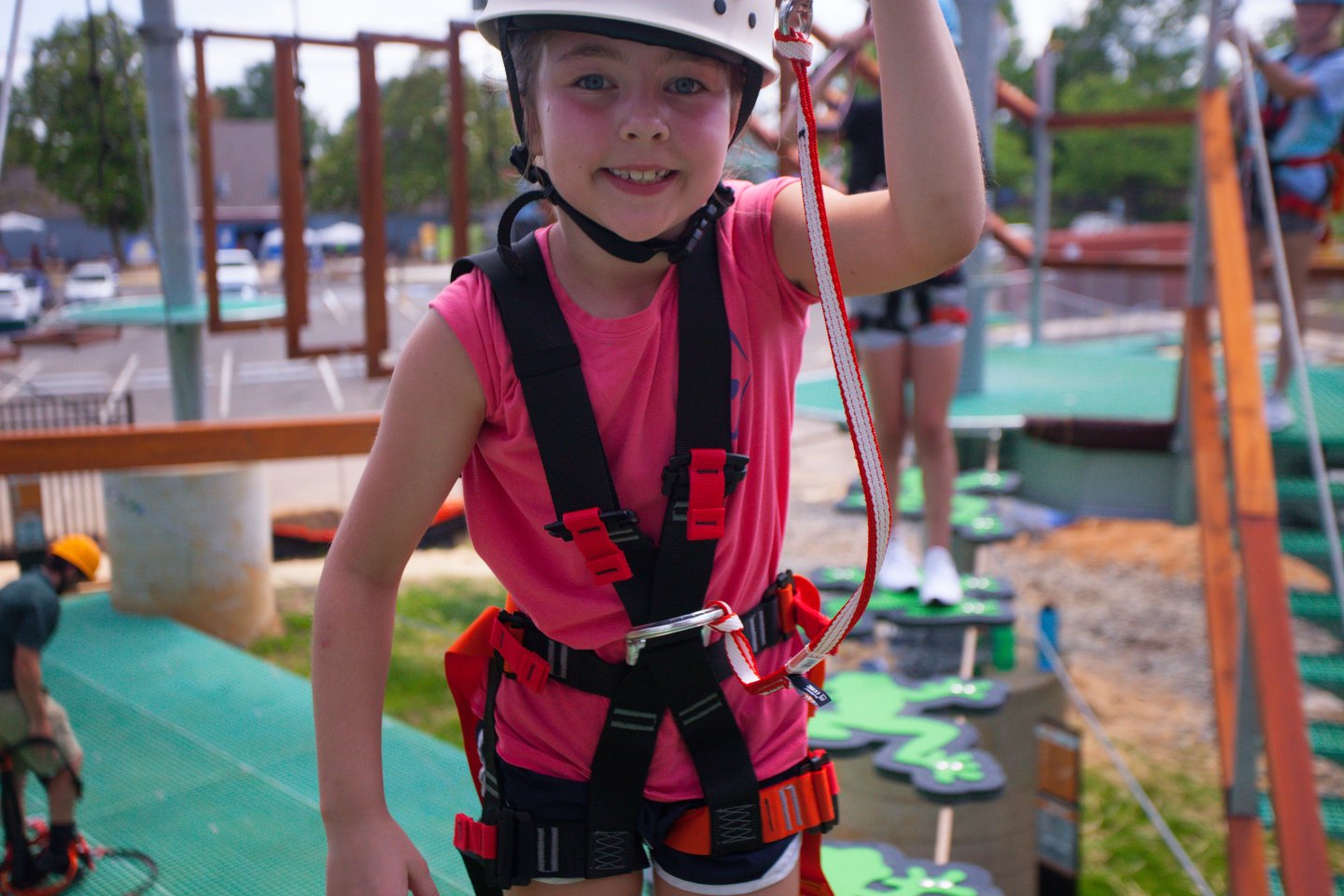girl smiling at the mirror wearing a white helmet on Climb UPton