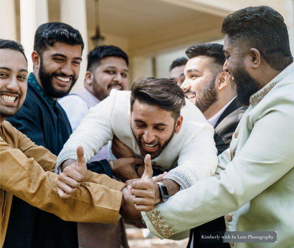 Grooms party holding up groom