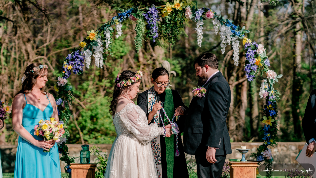 Bride and groom getting married with bridesmaid in turquoise dress
