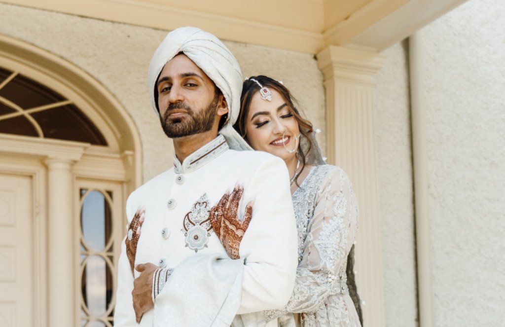 Bride and groom hugging on Rust Manor House patio