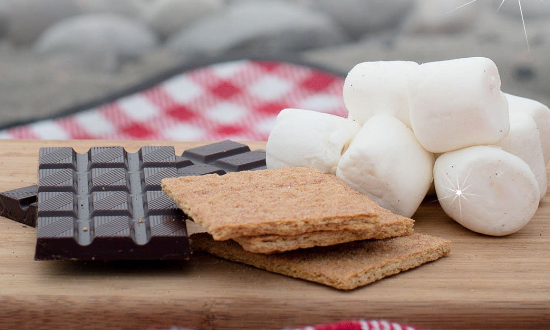 chocolate bar graham crackers and marshmallows on a wood board