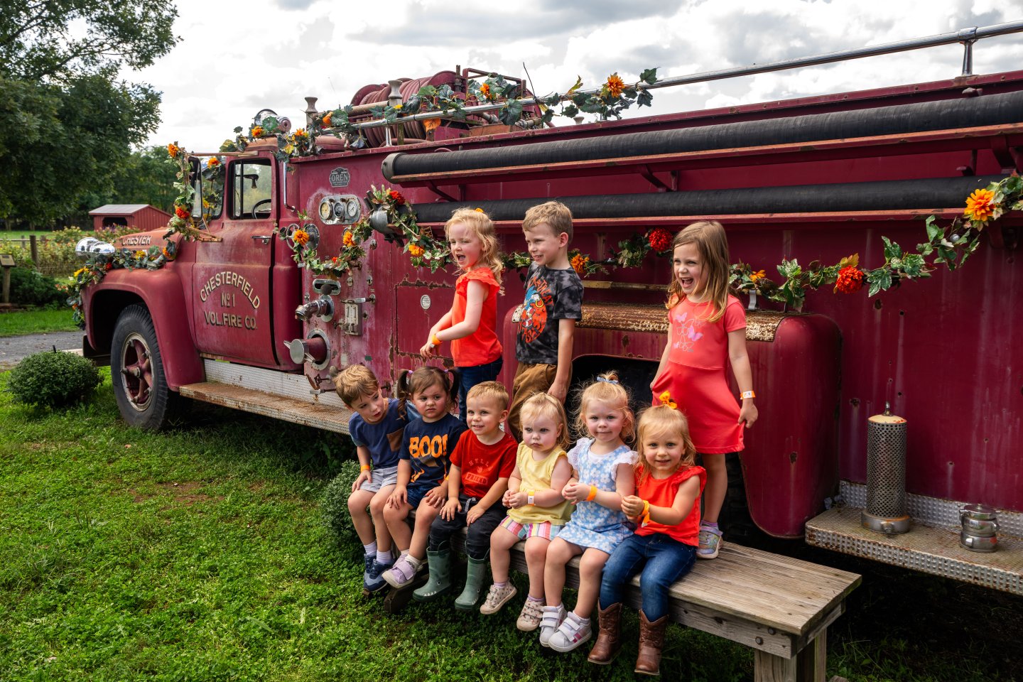Kids in front of old firetruck