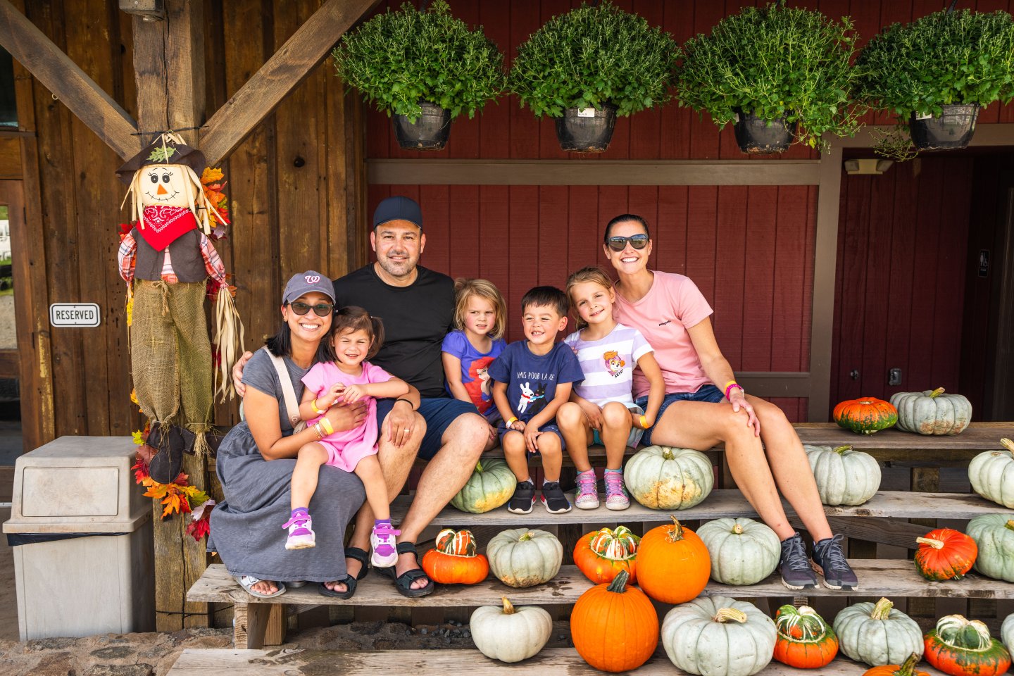 Family posing in front of pumpkins