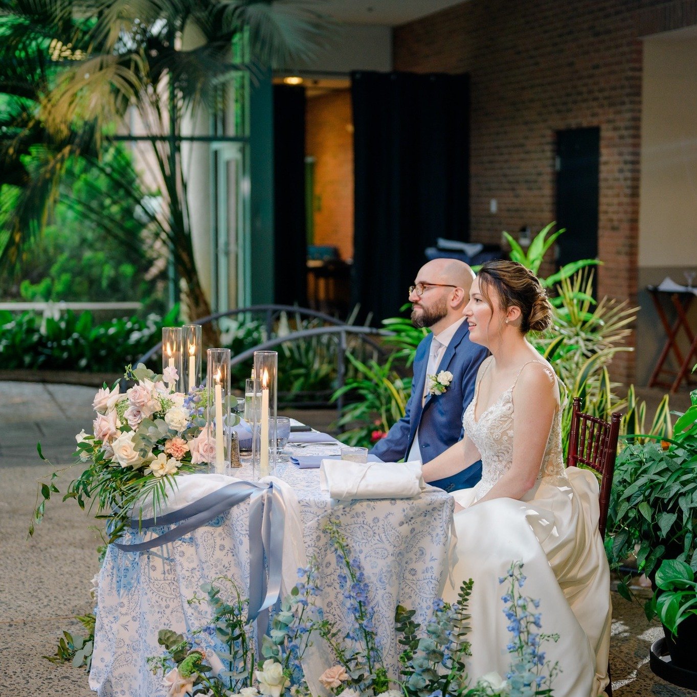 Newlyweds at table in event space