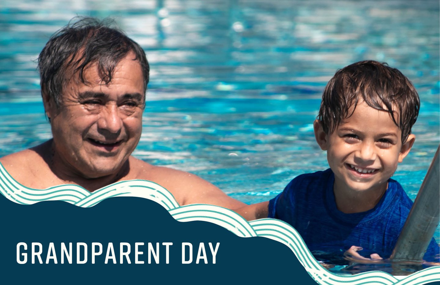 Grandparent and child smiling in a swimming pool.