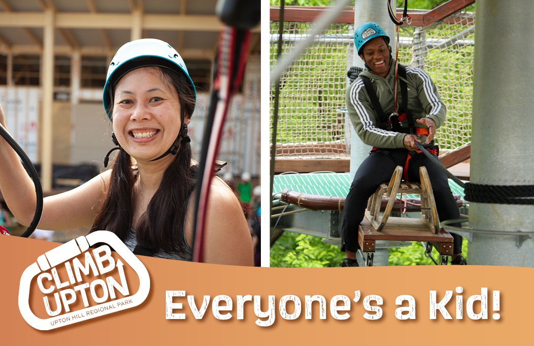 Two people in helmets enjoying a ropes course adventure.