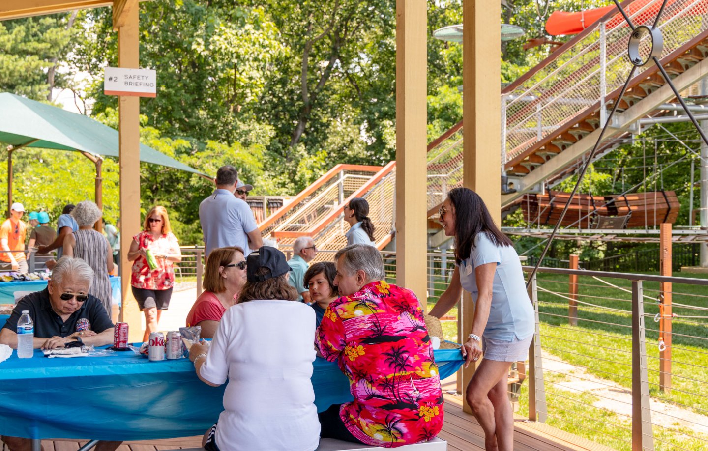 Large group chatting on deck at Climb UPton.