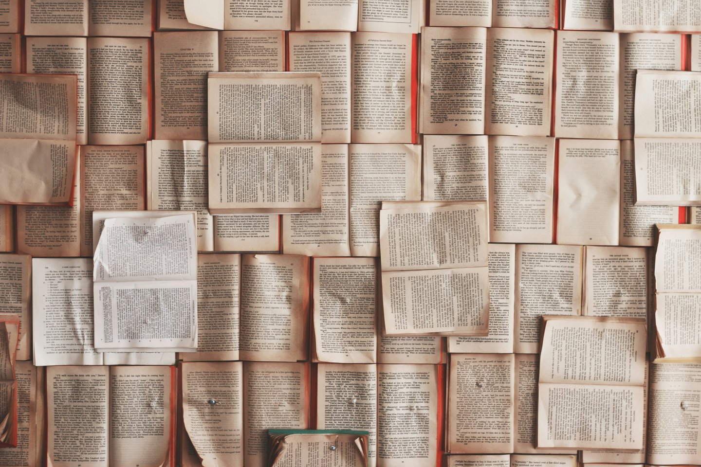 Open books arranged in a grid, showing various pages and texts.