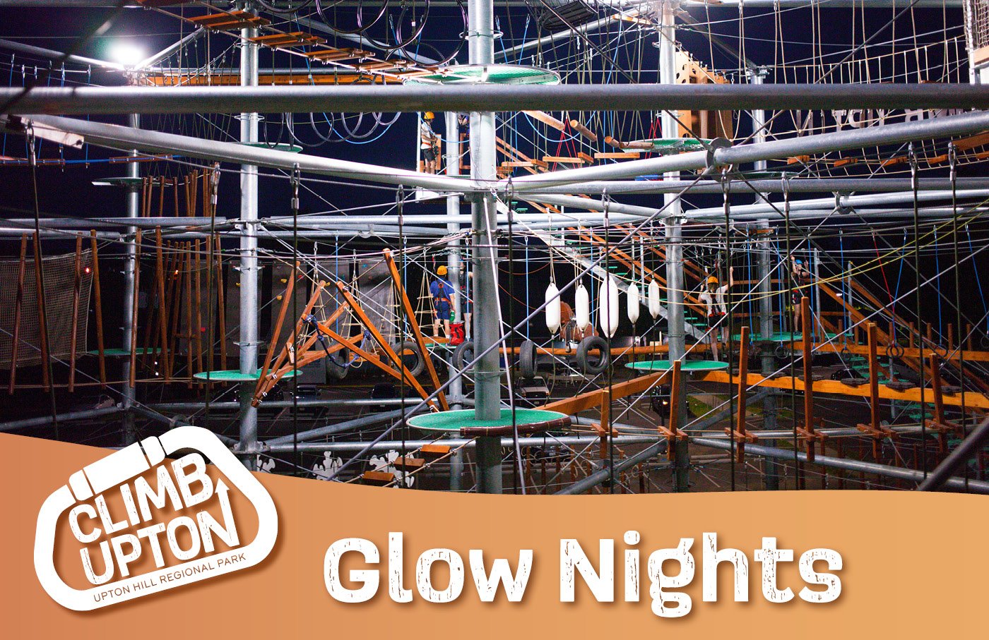 Rope course at night with glowing elements, "Climb Upton" logo.