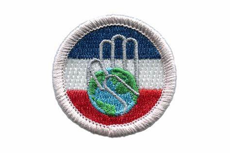 Embroidered badge with a hand and globe design on red, white, and blue stripes.