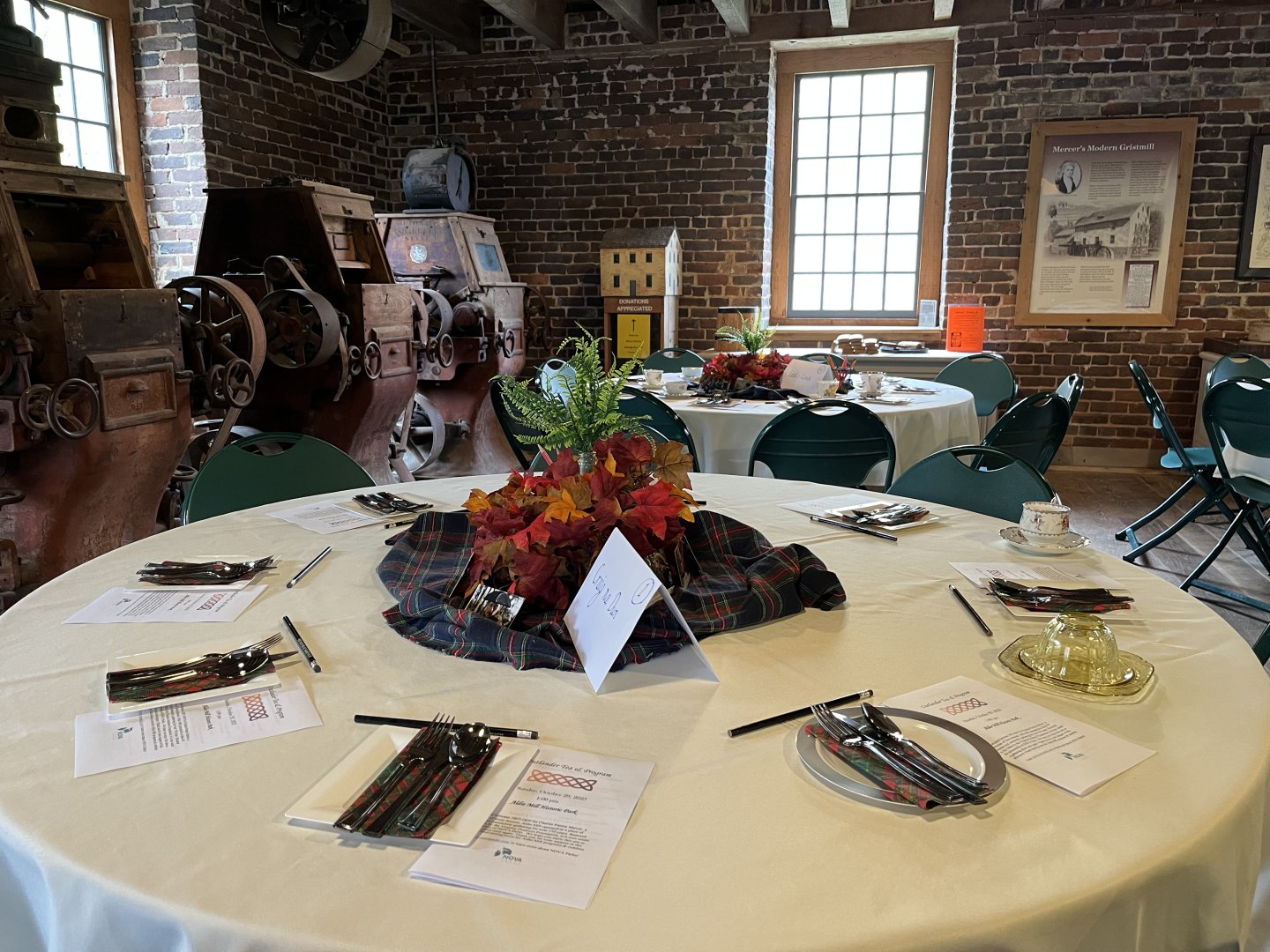 Elegant table setting in a rustic room with exposed brick walls.