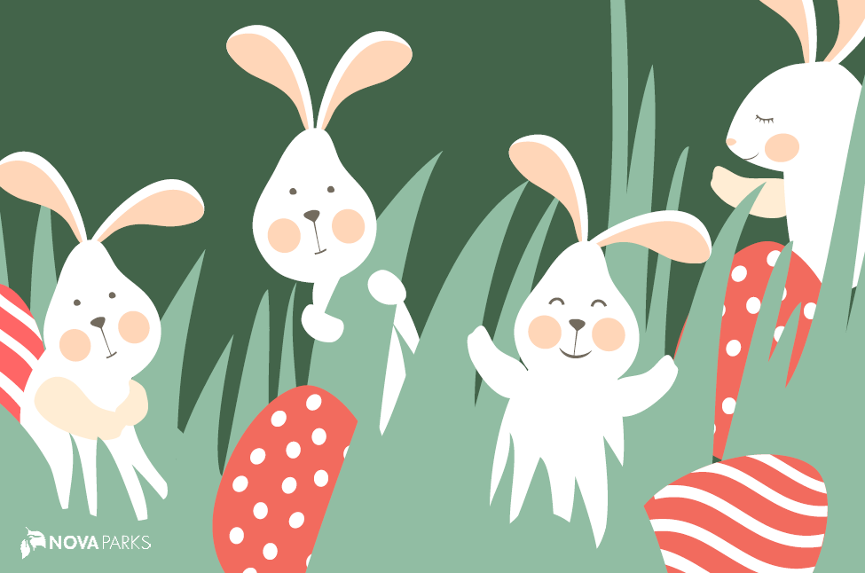 White rabbits with blush cheeks in grass with red polka dot eggs.