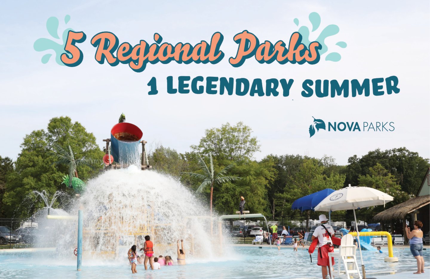 Water park with large splash bucket, children playing, and green trees.