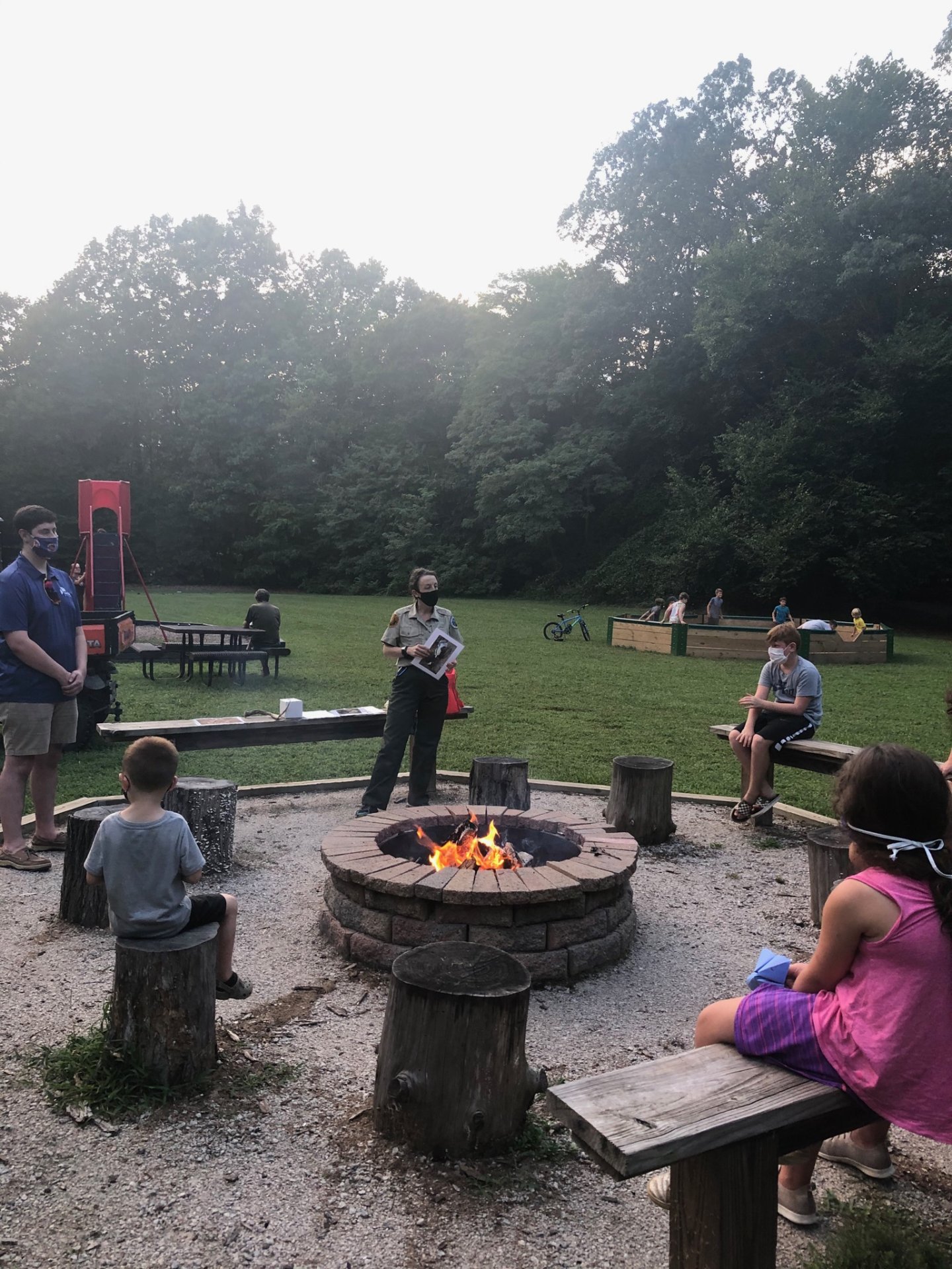campfire event with people wearing masks