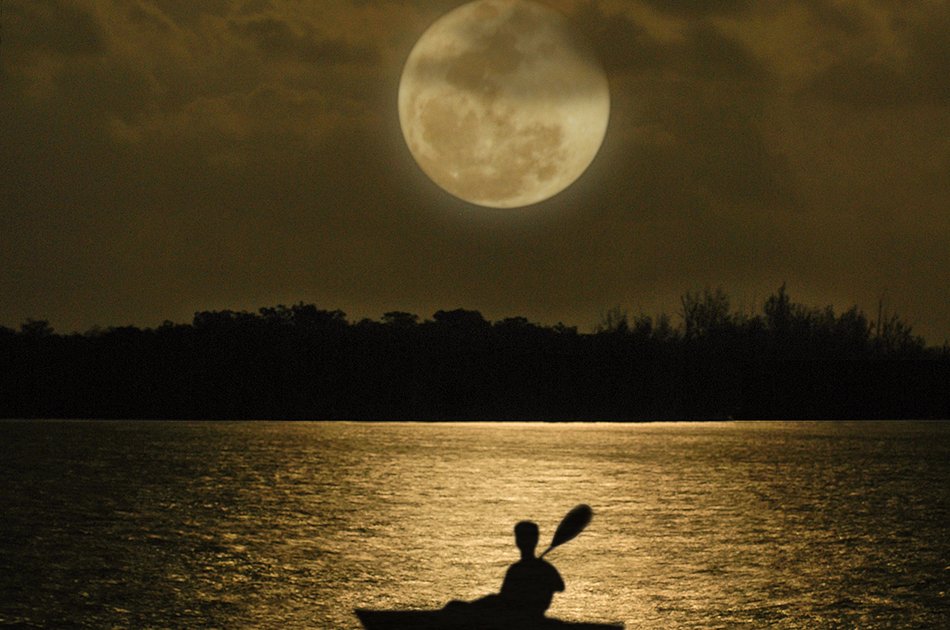 kayaker under the moonlight kayaker under the moonlight