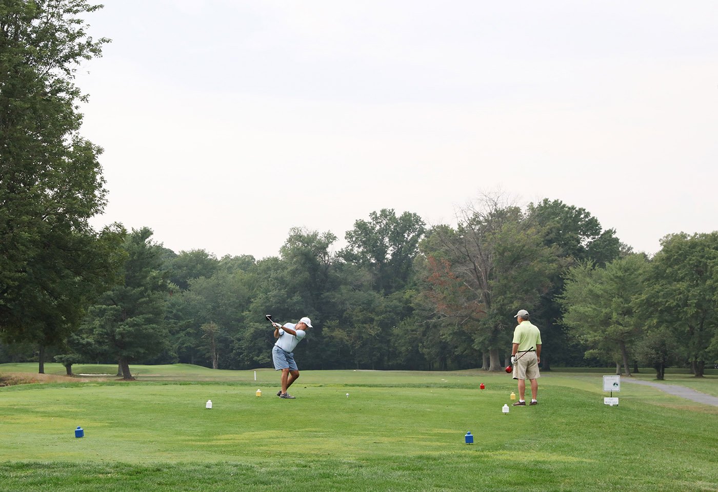 golfers teeing off golf course